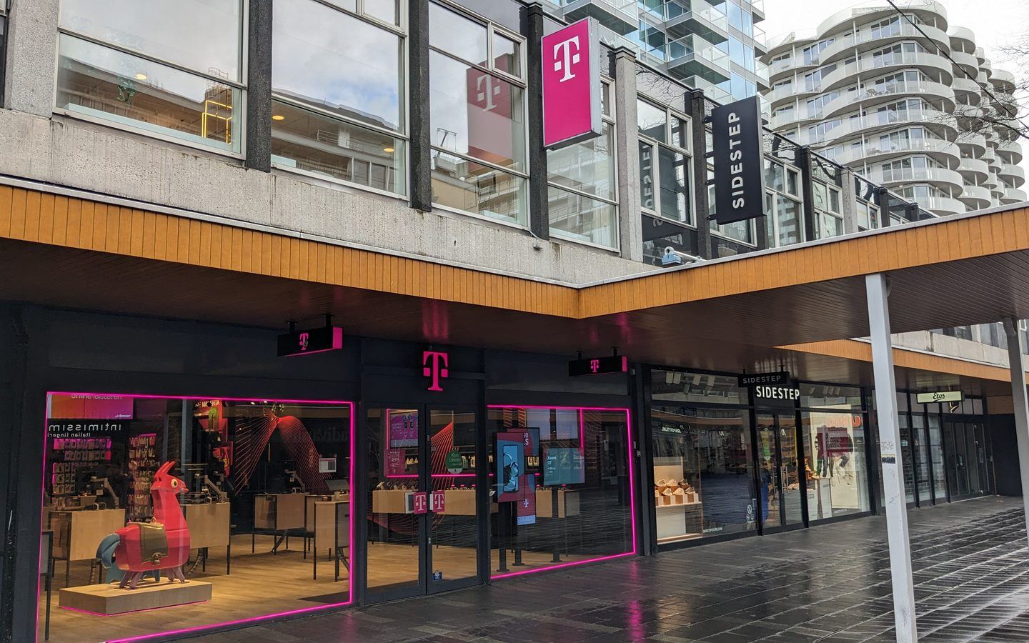 A modern T-Mobile store storefront with its magenta logo