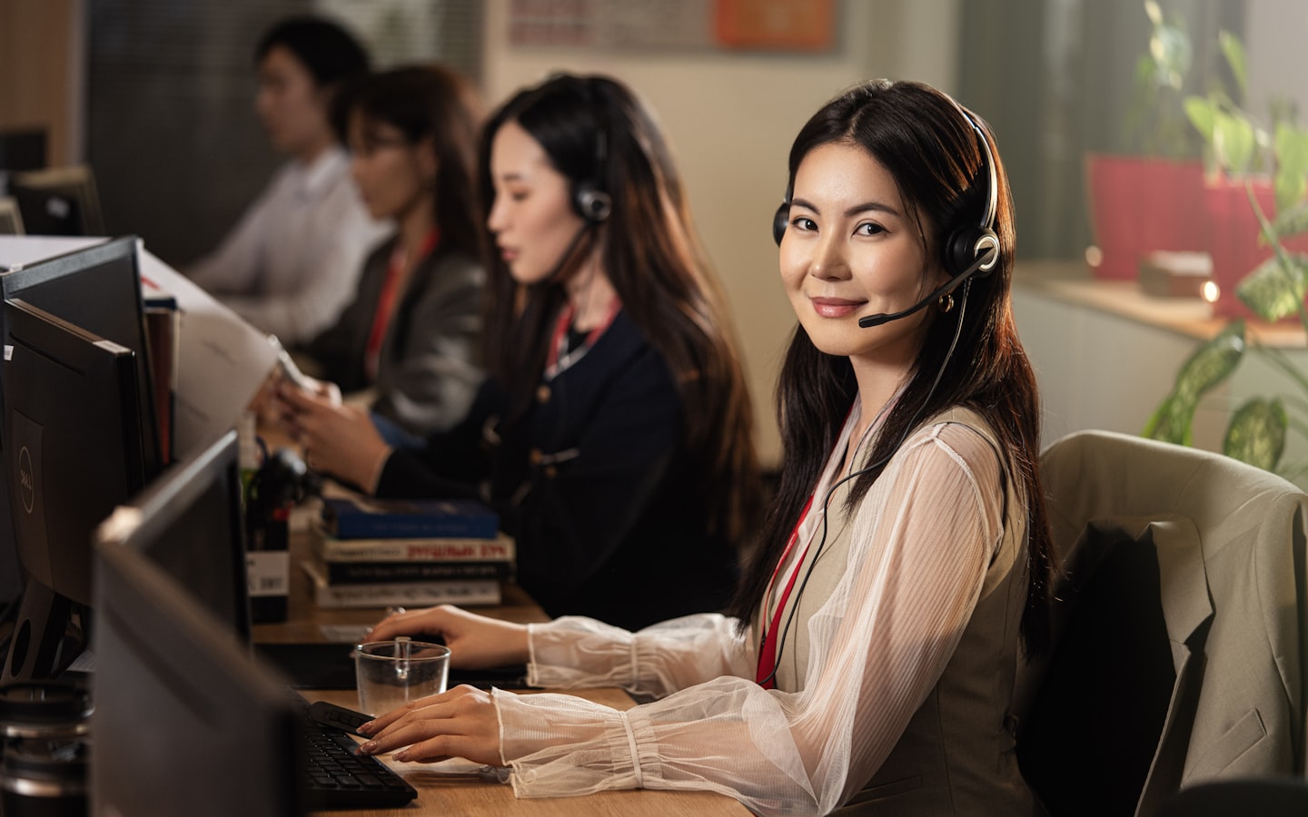 A call-centre agent wearing a headset at her desk